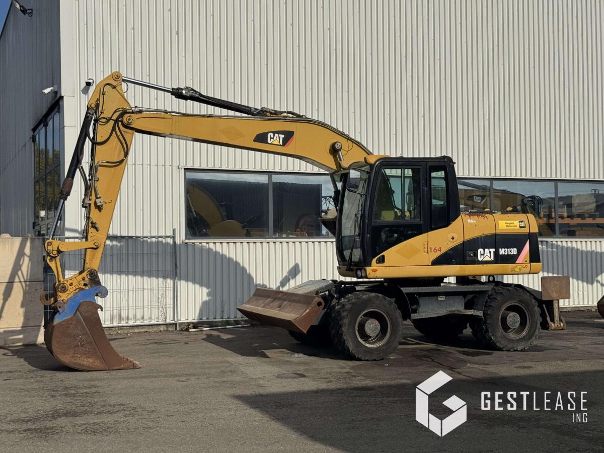 Caterpillar M313D - حفارة على عجلات: صور 1 Caterpillar M313D - حفارة على عجلات: صور 1