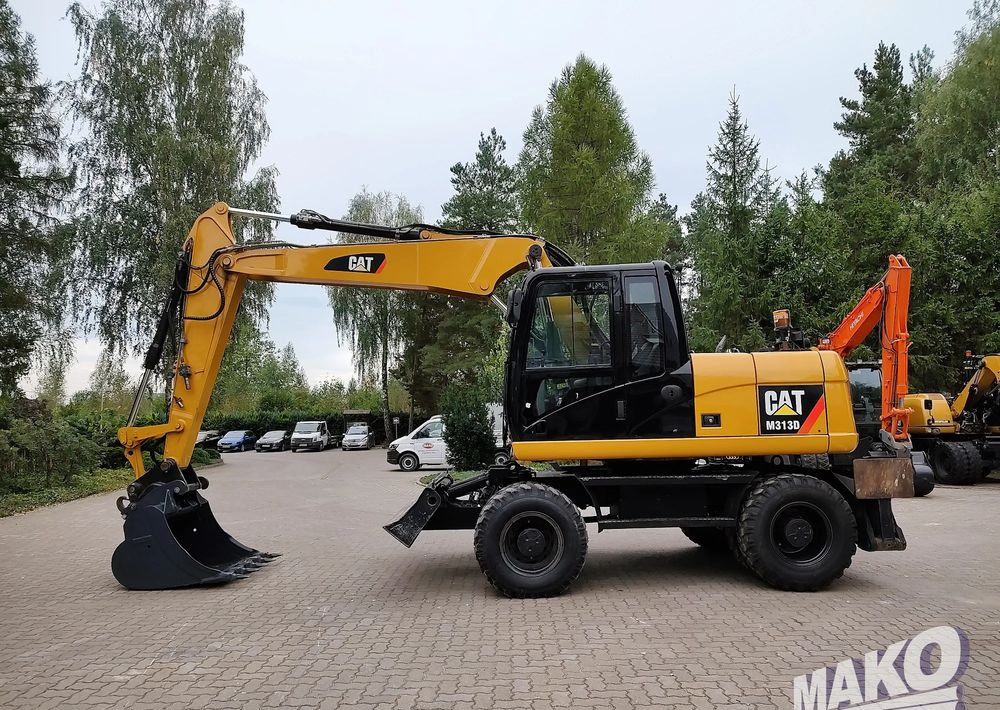 Caterpillar M313D - حفارة على عجلات: صور 1 Caterpillar M313D - حفارة على عجلات: صور 1