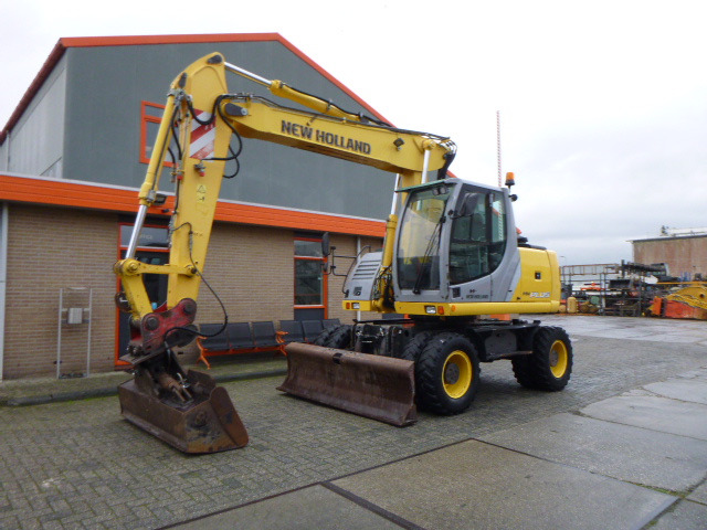 NEW HOLLAND MH PLUS - حفارة على عجلات: صور 1 NEW HOLLAND MH PLUS - حفارة على عجلات: صور 1