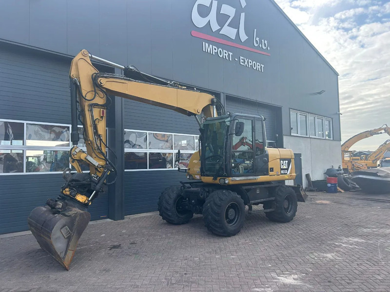 Caterpillar M313D - حفارة على عجلات: صور 1 Caterpillar M313D - حفارة على عجلات: صور 1