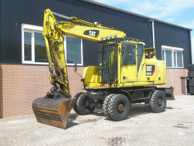 Caterpillar M318F - حفارة على عجلات: صور 1 Caterpillar M318F - حفارة على عجلات: صور 1