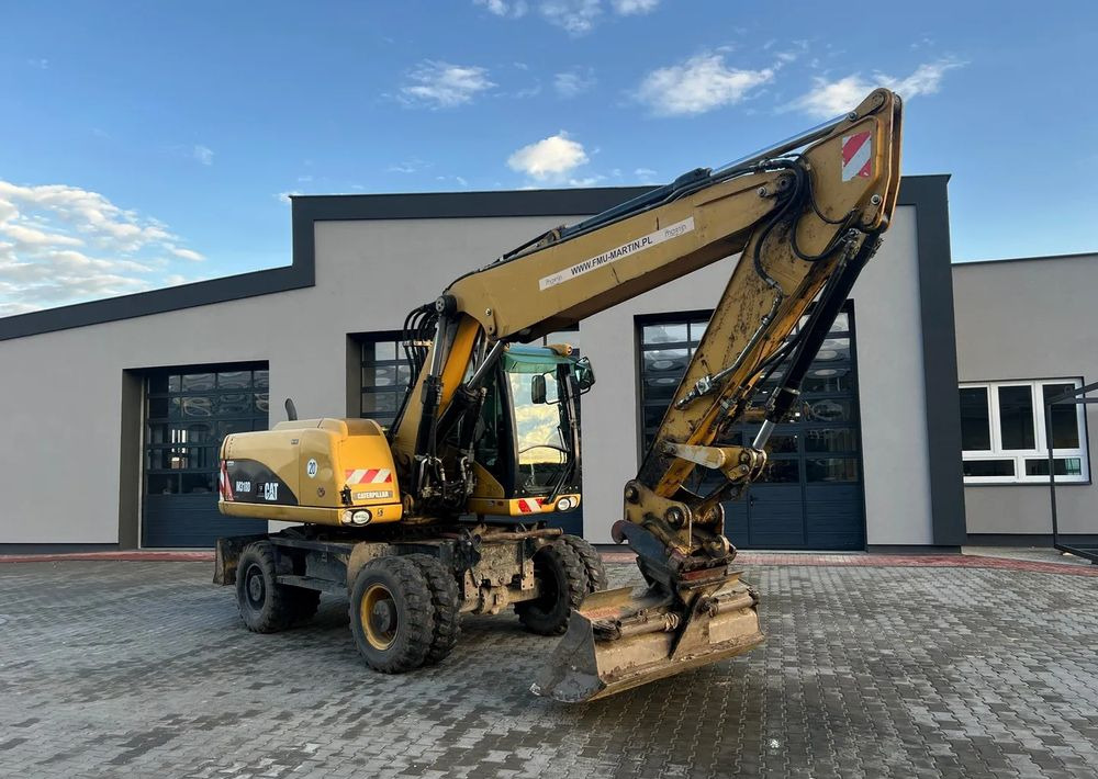 CAT Caterpillar M318D - حفارة على عجلات: صور 1 CAT Caterpillar M318D - حفارة على عجلات: صور 1